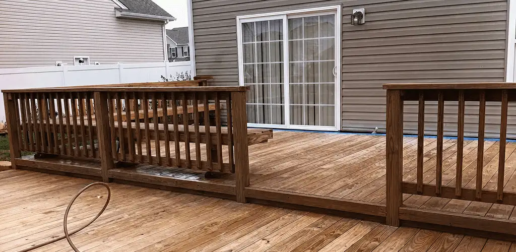 Deck sealing service protecting a backyard wood deck and railings in Chicago, IL