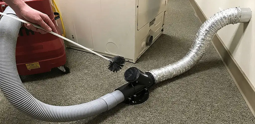 Dryer vent cleaning service removing lint from a dryer duct connection in Chicago, IL