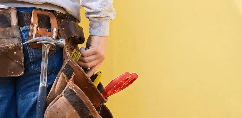 Handyman with tool belt ready for home repairs and maintenance in Chicago, IL