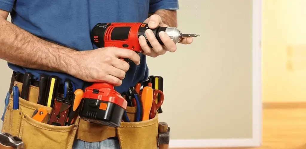 Handyman holding a power drill for home repairs and installations in Chicago, IL