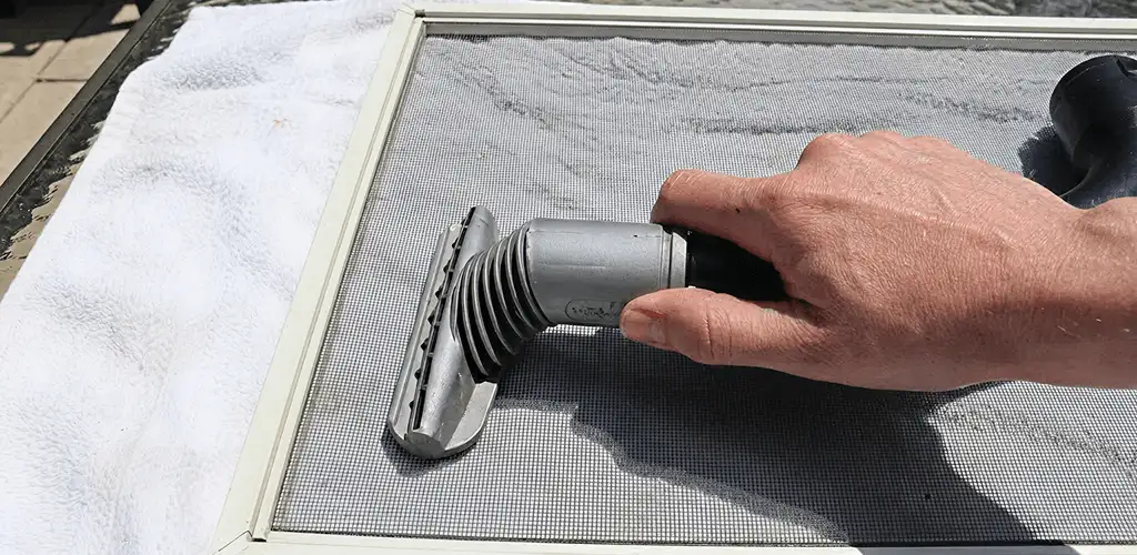 Window screen repair cleaning and fixing a damaged screen mesh in Chicago, IL
